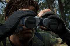 Naked Snake looking through his binoculars to scout enemies in the region in Metal Gear Solid Delta: Snake Eater.